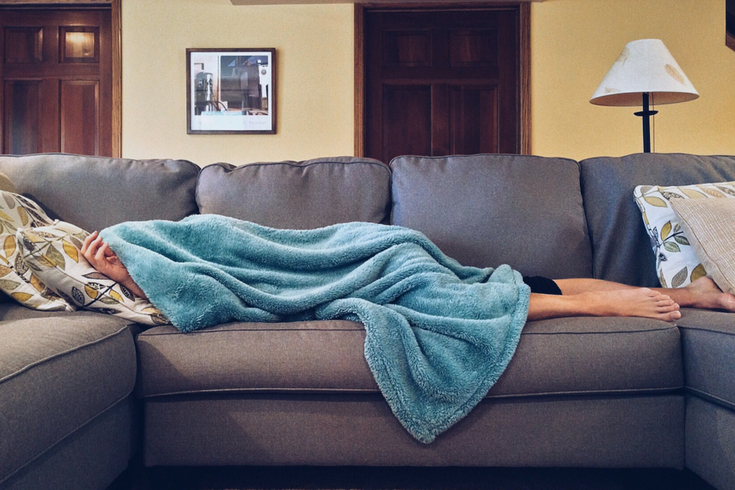 Unmotivated person is lounging on a couch